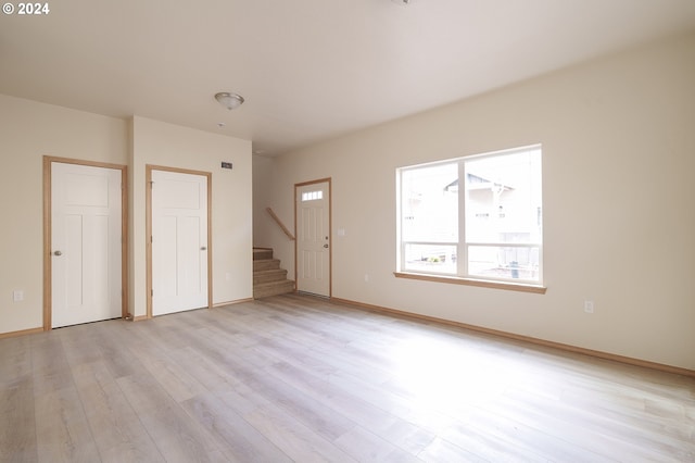 spare room with light hardwood / wood-style flooring