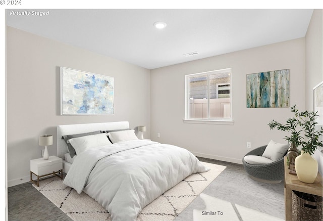 carpeted bedroom featuring baseboards and visible vents