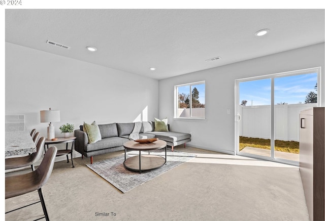 living room featuring recessed lighting, visible vents, and baseboards