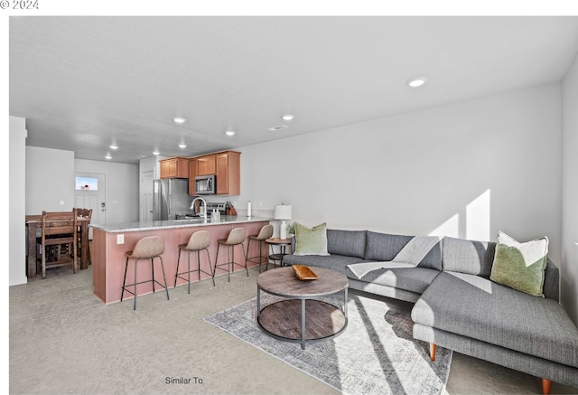 living room featuring recessed lighting and light carpet