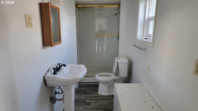 bathroom with toilet, wood-type flooring, and walk in shower