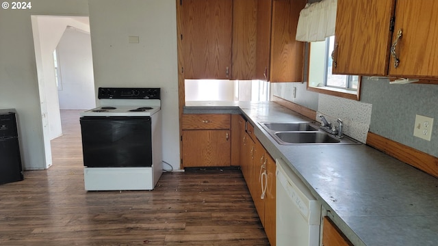 kitchen featuring decorative backsplash, white appliances, dark hardwood / wood-style floors, and sink