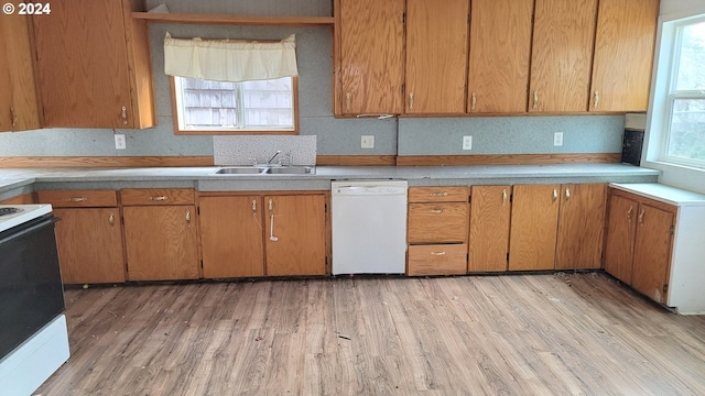 kitchen with sink, light hardwood / wood-style floors, and white appliances