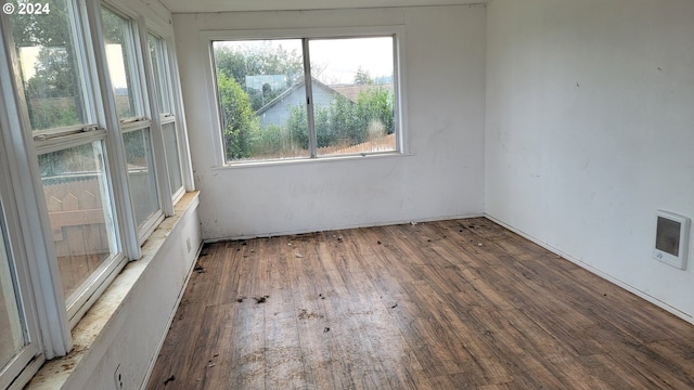 unfurnished room featuring a healthy amount of sunlight and wood-type flooring