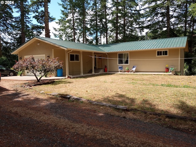 ranch-style home featuring a garage and a front lawn