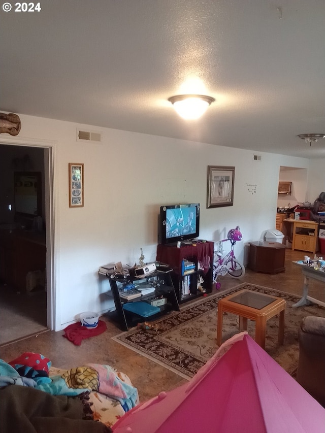 carpeted living room featuring a textured ceiling