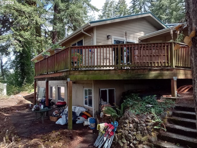 rear view of house featuring a deck