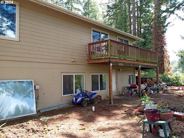 back of house featuring a balcony and a patio area