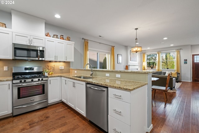 kitchen with white cabinets, stainless steel appliances, and dark hardwood / wood-style floors