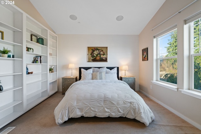 carpeted bedroom featuring lofted ceiling