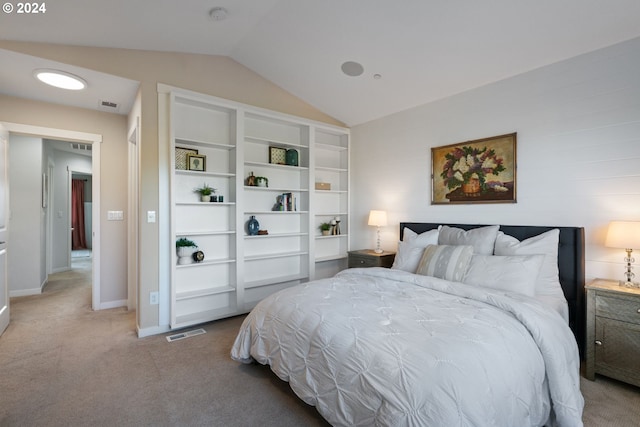 bedroom with carpet floors and lofted ceiling