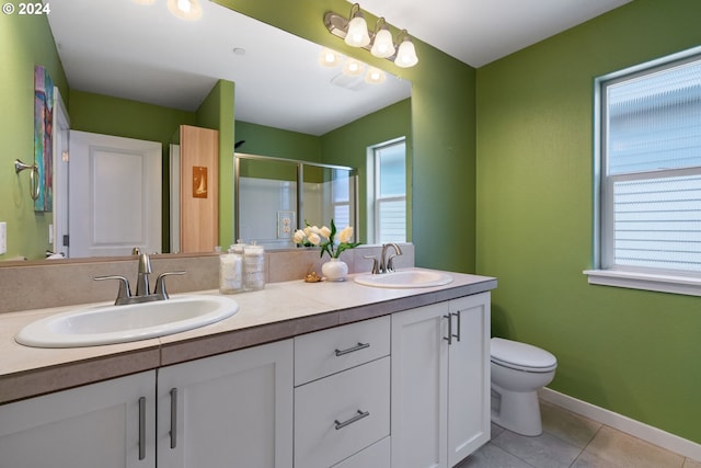 bathroom with tile patterned floors, plenty of natural light, and vanity