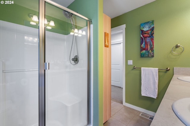 bathroom with tile patterned floors, vanity, and walk in shower