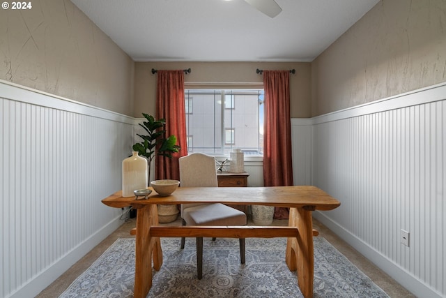 carpeted home office with ceiling fan