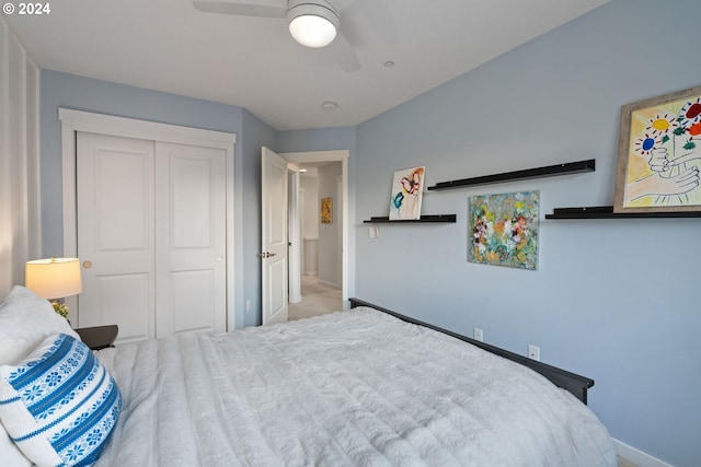 carpeted bedroom featuring a closet and ceiling fan