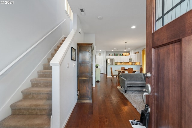 foyer entrance with dark wood-type flooring