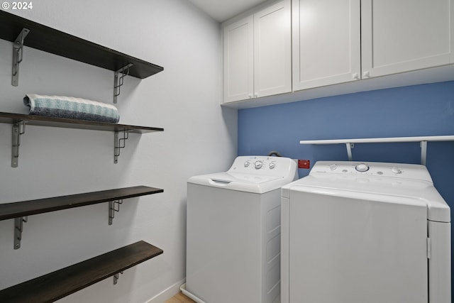 washroom featuring cabinets and separate washer and dryer