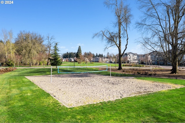 view of home's community featuring volleyball court and a yard