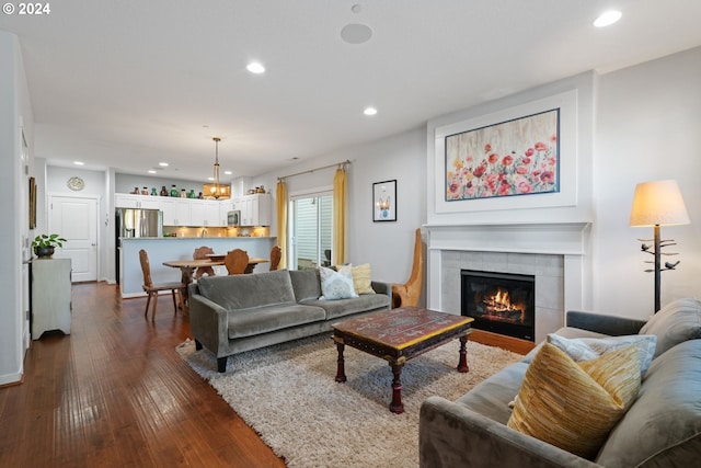 living room with dark hardwood / wood-style floors and a fireplace