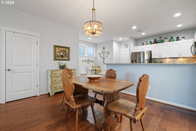 dining room with a chandelier and dark hardwood / wood-style floors