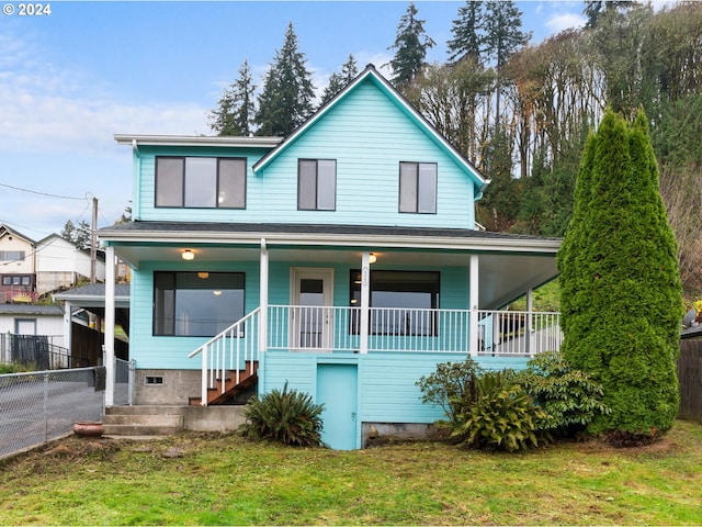 view of front of property with a front yard and a porch