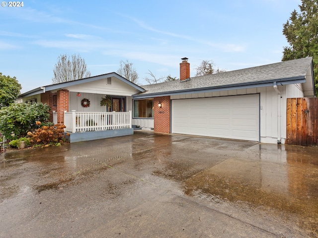 ranch-style house with a garage and covered porch