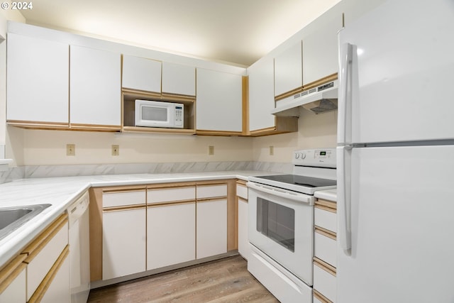 kitchen with light wood-type flooring, white appliances, and white cabinetry