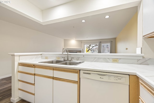 kitchen featuring white cabinetry, sink, dark wood-type flooring, kitchen peninsula, and white dishwasher