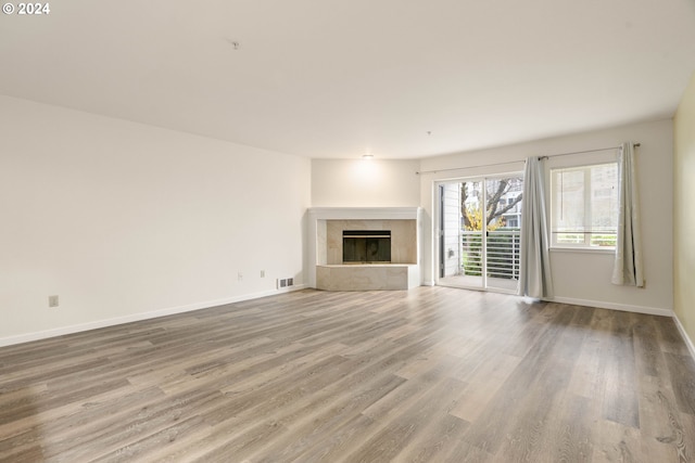 unfurnished living room featuring a fireplace and hardwood / wood-style floors