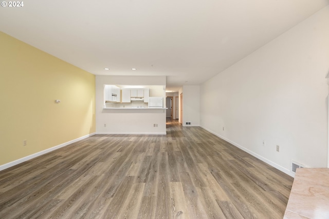 unfurnished living room with dark wood-type flooring