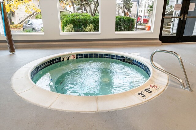 view of swimming pool with a community hot tub