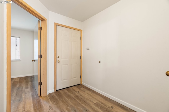 corridor with wood-type flooring