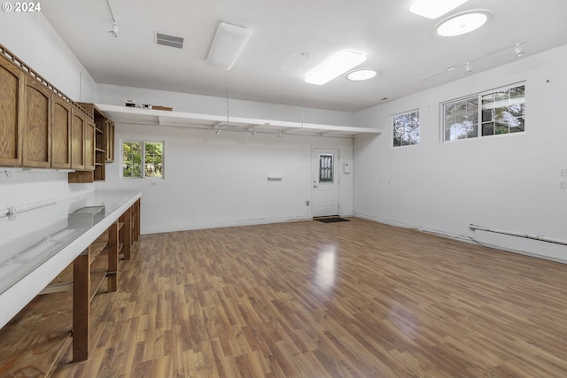 washroom with dark hardwood / wood-style floors and track lighting