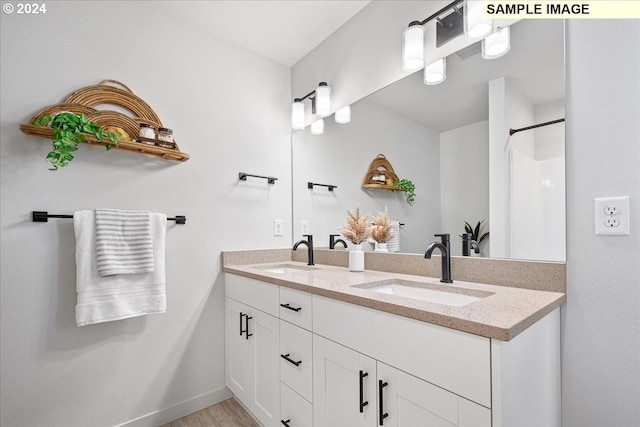 bathroom with vanity and hardwood / wood-style flooring