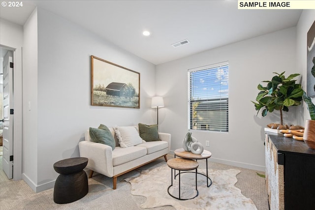 living area featuring light carpet