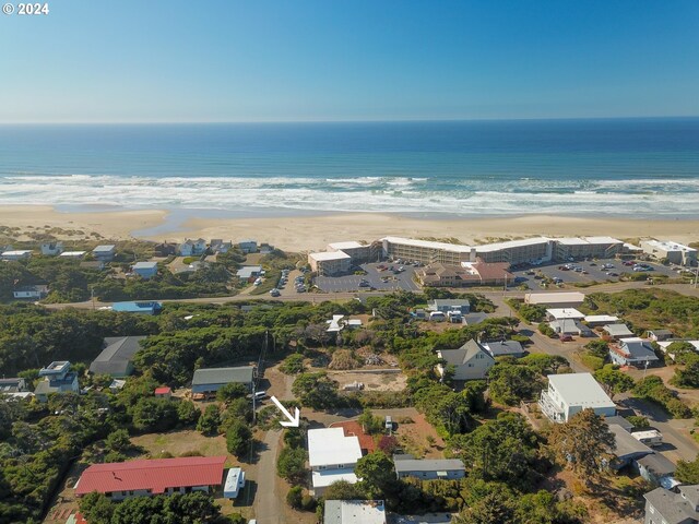 aerial view with a water view and a beach view
