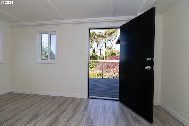 foyer entrance featuring light wood finished floors and baseboards