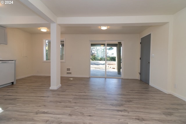 interior space featuring light wood-style floors, baseboards, and heating unit