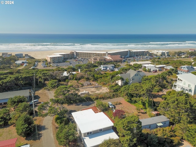 bird's eye view featuring a water view and a beach view