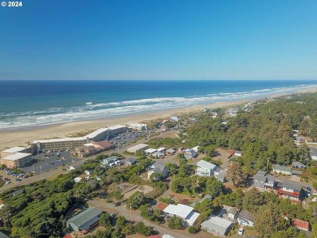bird's eye view featuring a water view and a beach view
