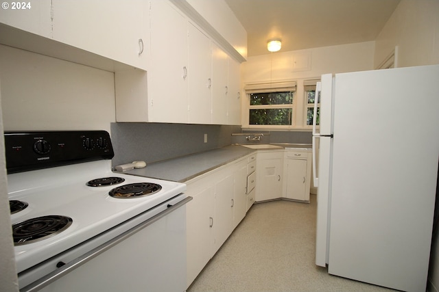 kitchen with white cabinetry, sink, and white appliances