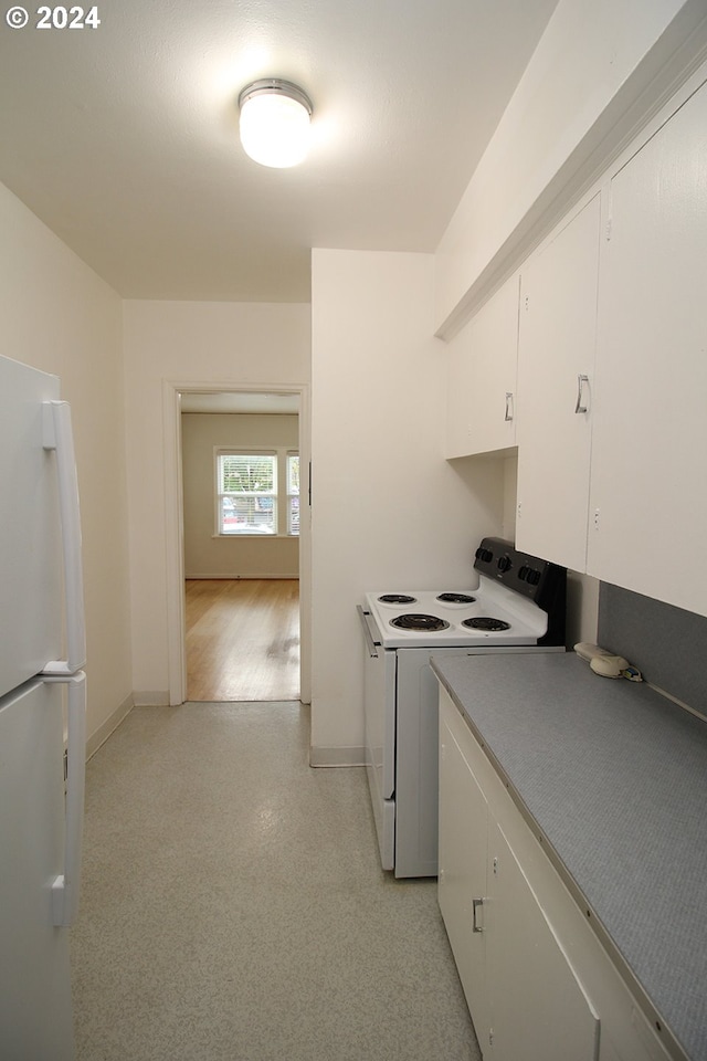 kitchen with white appliances and white cabinets