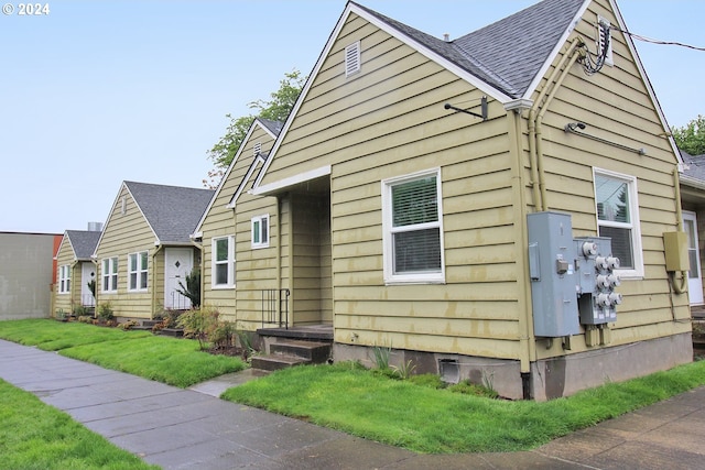 view of side of property with a lawn