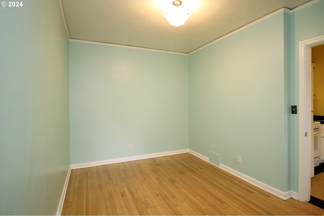 empty room with light hardwood / wood-style flooring and ornamental molding