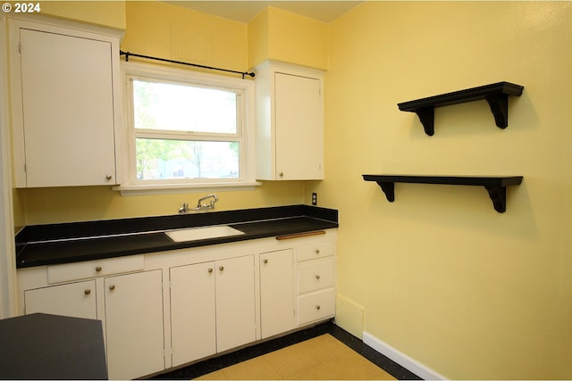 kitchen featuring sink and white cabinets