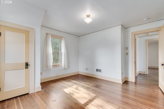 unfurnished room featuring hardwood / wood-style flooring