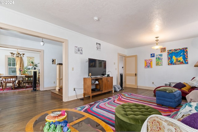 170 N Jefferson St, Eugene, OR 97402 - living area featuring wood finished floors, a chandelier, ornamental molding, and a textured ceiling