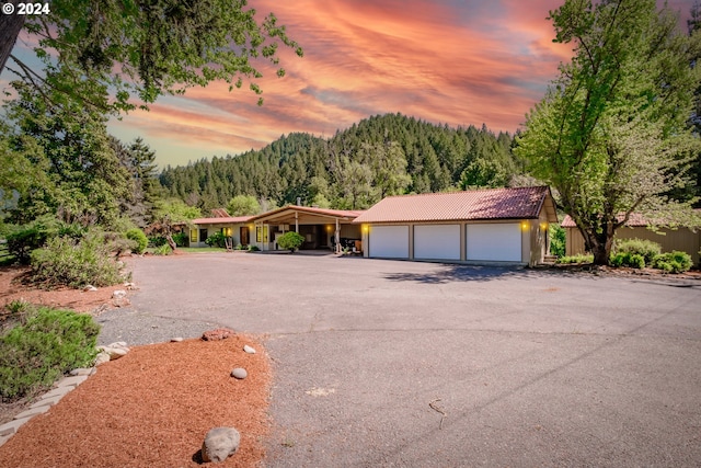 view of front of property with a garage and an outdoor structure