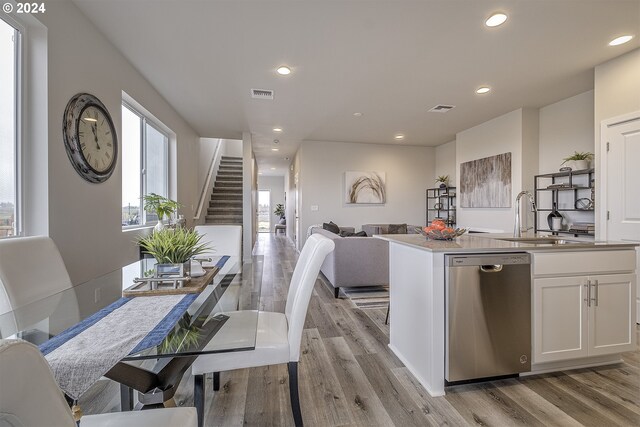 3598 Ash St, Forest Grove, OR 97116 - kitchen with dishwasher, open floor plan, light wood-style flooring, white cabinetry, and a sink