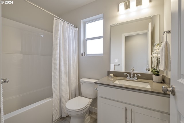 full bathroom with vanity, shower / tub combo, and toilet